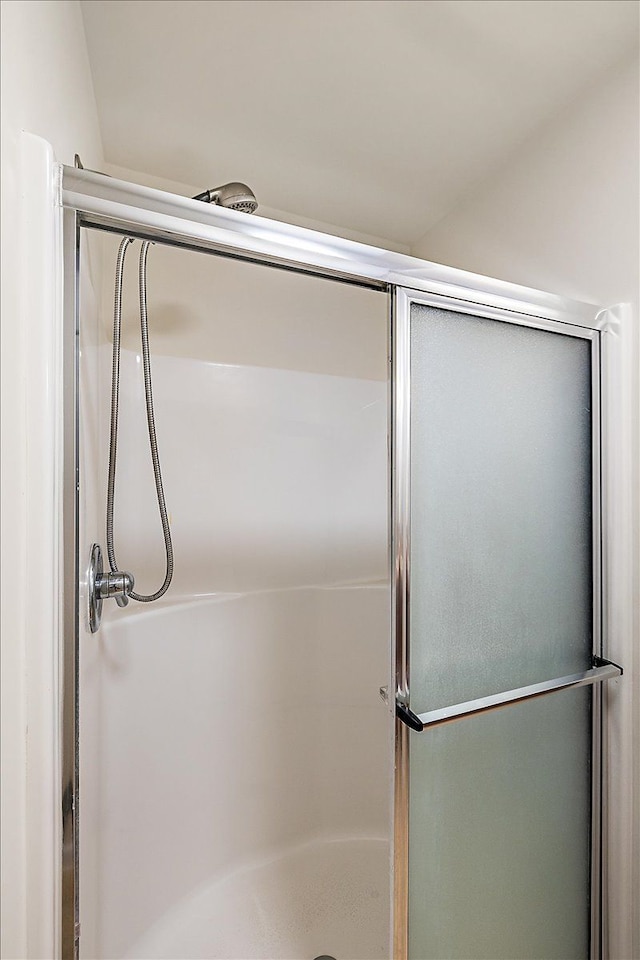 bathroom with a shower with shower door