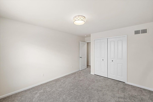 unfurnished bedroom with a closet and carpet floors