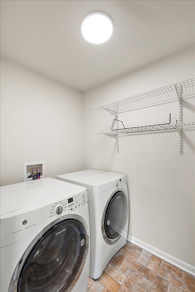 clothes washing area featuring separate washer and dryer