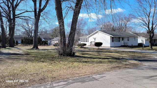 view of side of home with a lawn