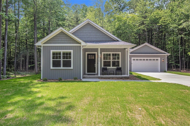 view of front of home featuring covered porch, a front lawn, and a garage