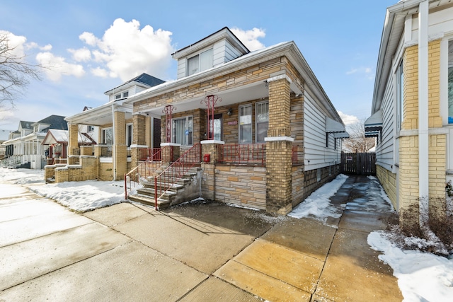 view of front of house featuring covered porch and brick siding