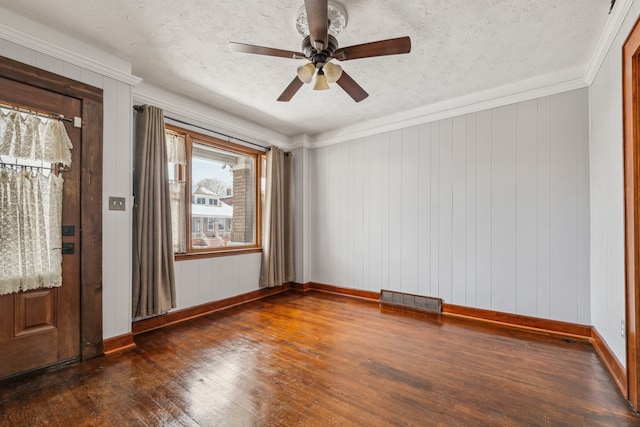 entryway featuring a textured ceiling, dark wood-type flooring, visible vents, and baseboards