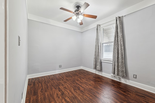 empty room with a ceiling fan, visible vents, baseboards, and wood finished floors