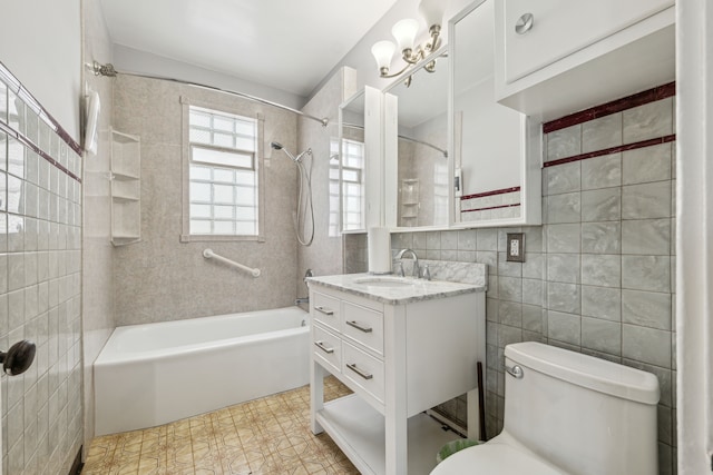 full bathroom with shower / bath combination, toilet, tile walls, and vanity