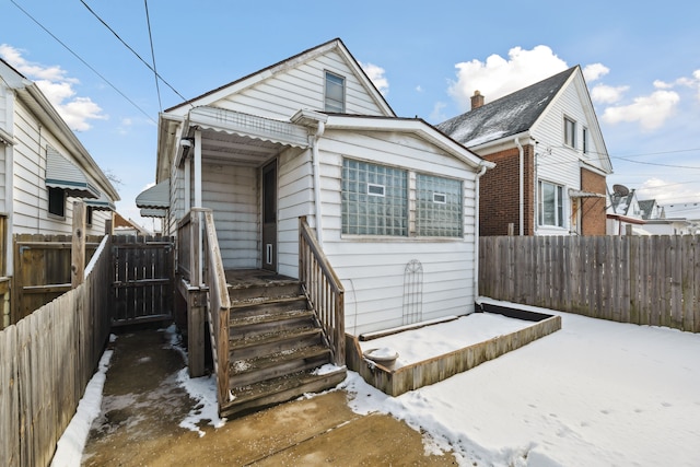 bungalow-style home with fence