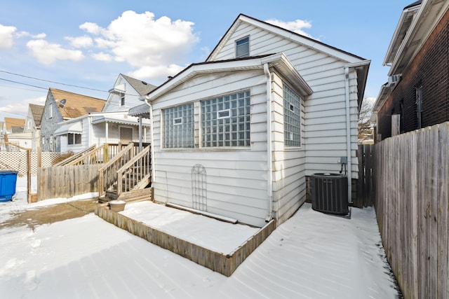 view of front of house with fence private yard and central AC unit