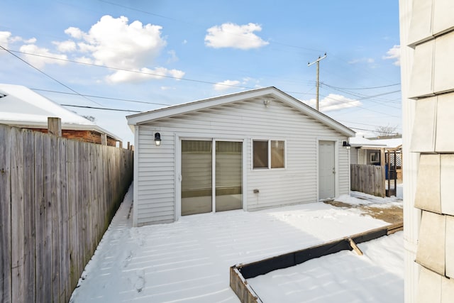 rear view of property with fence and a wooden deck