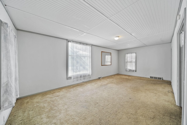 unfurnished room with carpet flooring and plenty of natural light