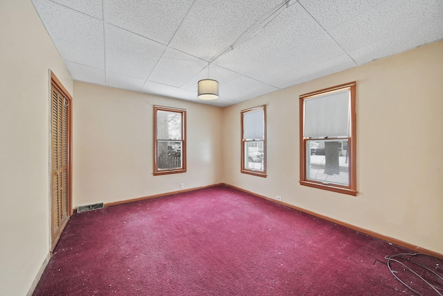 unfurnished room featuring dark colored carpet