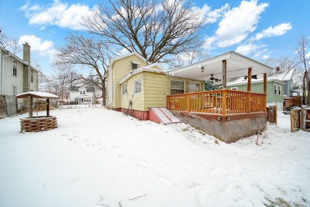 snow covered property featuring a wooden deck