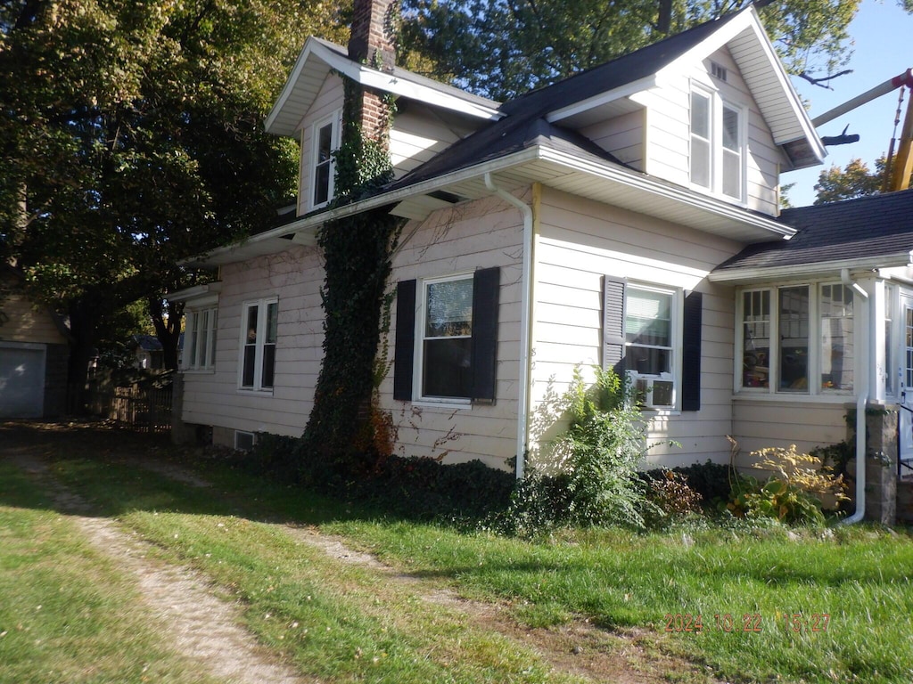 view of property exterior with a yard