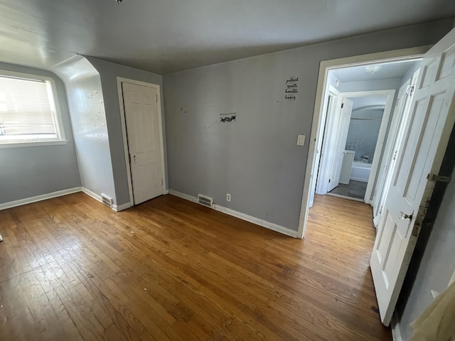 unfurnished bedroom with hardwood / wood-style floors