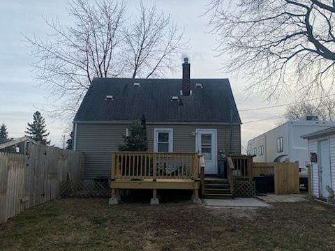 rear view of property featuring a deck