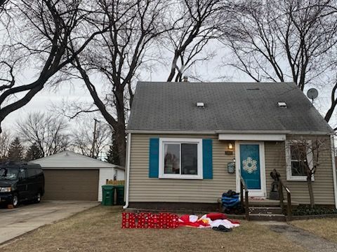 view of front of home with a garage and an outdoor structure