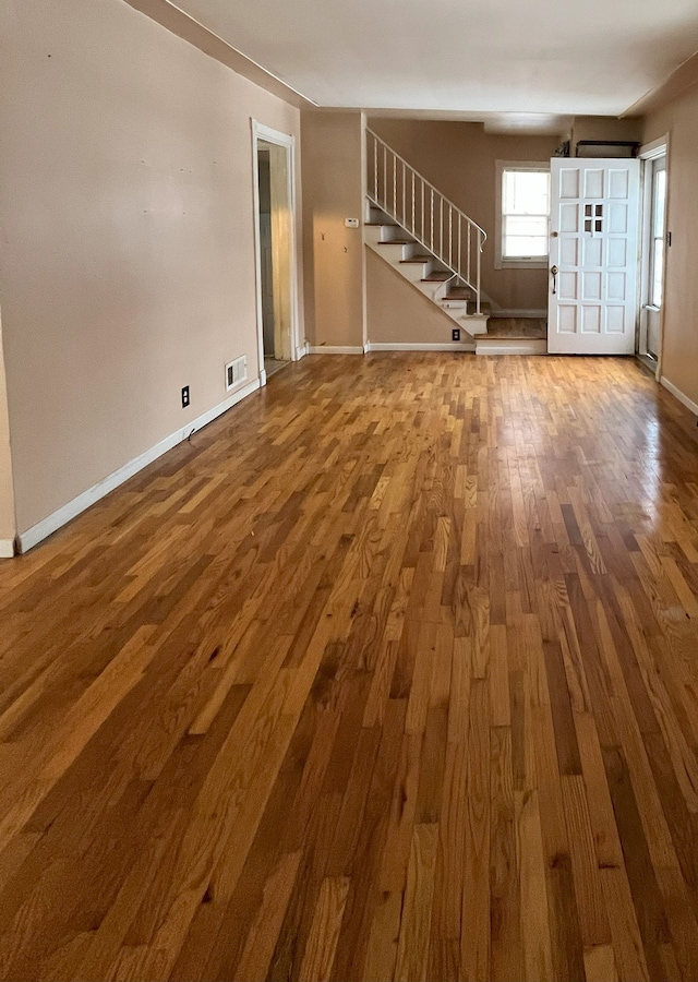 unfurnished living room featuring hardwood / wood-style flooring