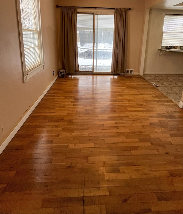 empty room with hardwood / wood-style flooring