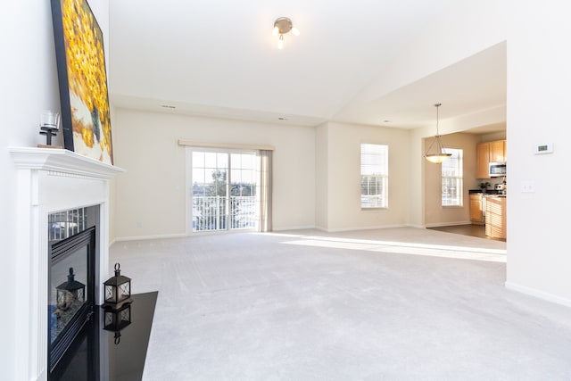 living room with light colored carpet and vaulted ceiling