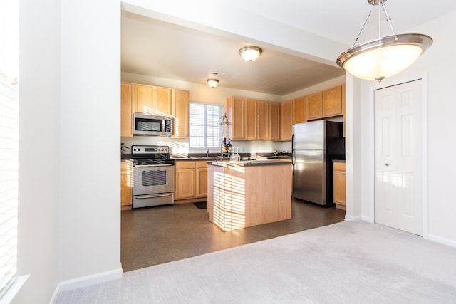 kitchen featuring light brown cabinetry, pendant lighting, appliances with stainless steel finishes, and a center island