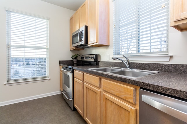 kitchen with light brown cabinetry, sink, and appliances with stainless steel finishes