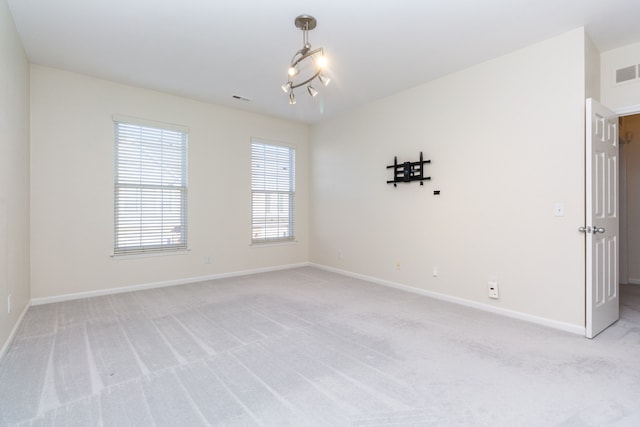 unfurnished room with light colored carpet