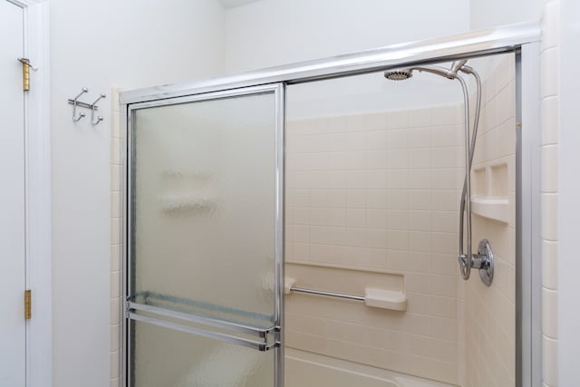 bathroom with a shower with shower door