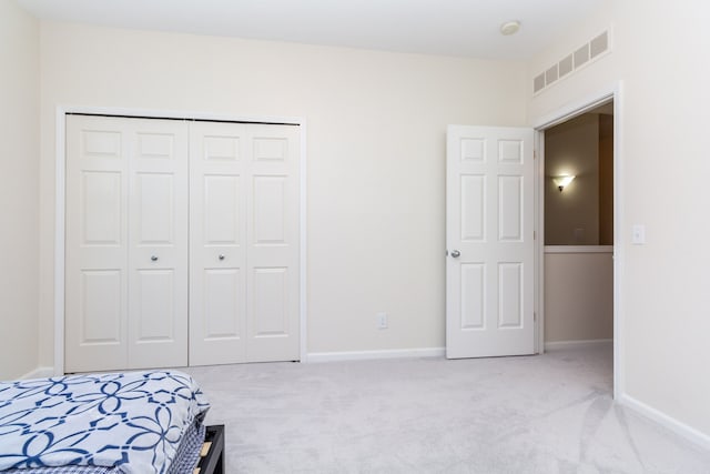 carpeted bedroom with a closet