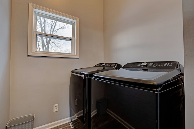 laundry room featuring dark hardwood / wood-style flooring and separate washer and dryer