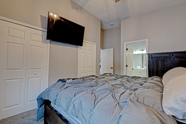 bedroom featuring carpet floors, connected bathroom, and a textured ceiling