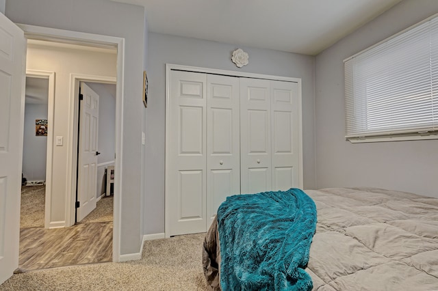 carpeted bedroom with a closet