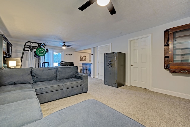 living room with ceiling fan, a textured ceiling, and carpet flooring