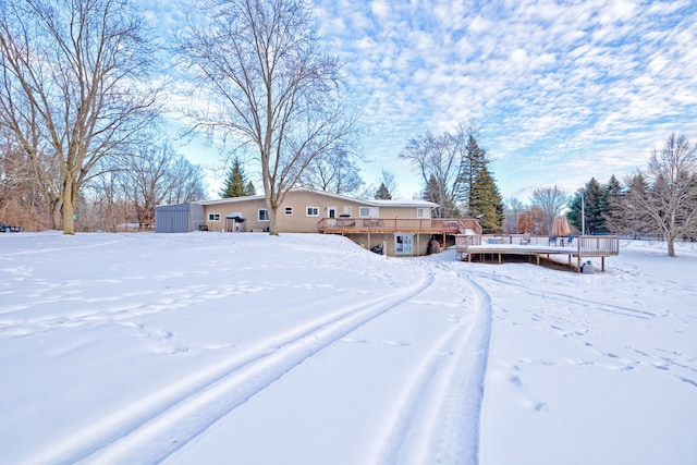 yard covered in snow featuring a wooden deck