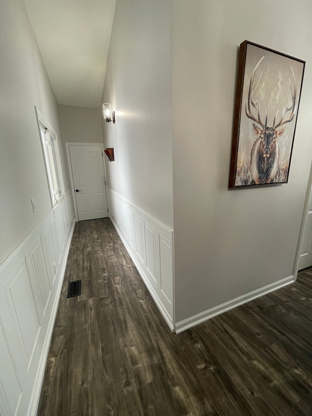 corridor with dark wood-type flooring