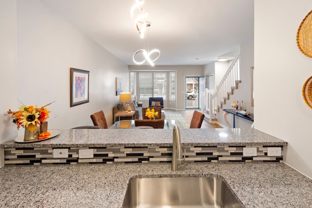 kitchen featuring sink and light stone counters