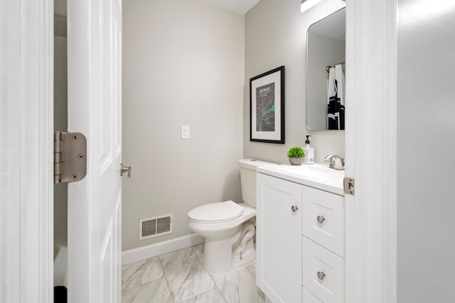 bathroom featuring toilet and vanity