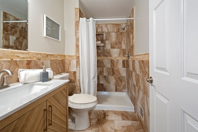 bathroom with toilet, tile walls, a shower with curtain, and vanity