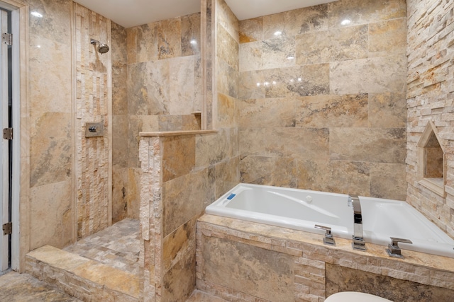 bathroom with tile walls and plus walk in shower