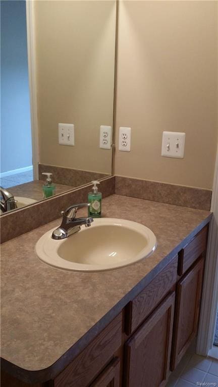 bathroom with tile patterned floors and vanity