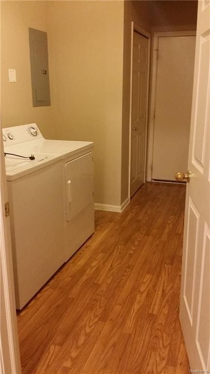 laundry area featuring light hardwood / wood-style flooring, washer and clothes dryer, and electric panel