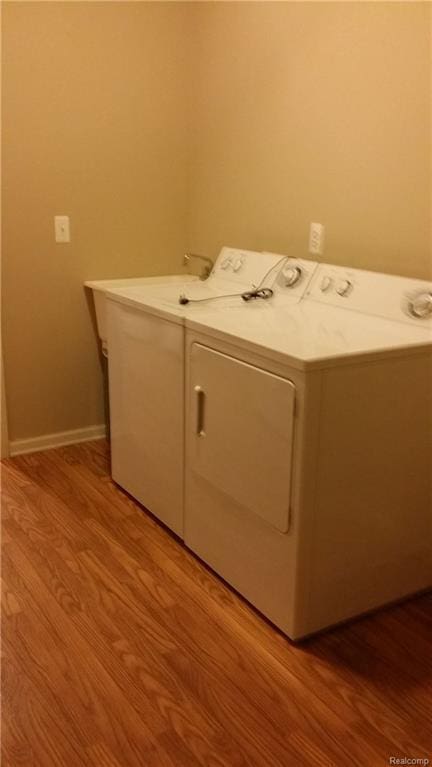 laundry area featuring light hardwood / wood-style floors and independent washer and dryer