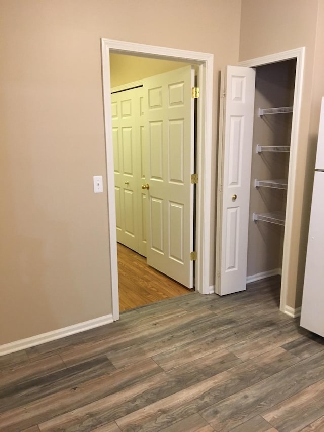 hall with dark hardwood / wood-style flooring