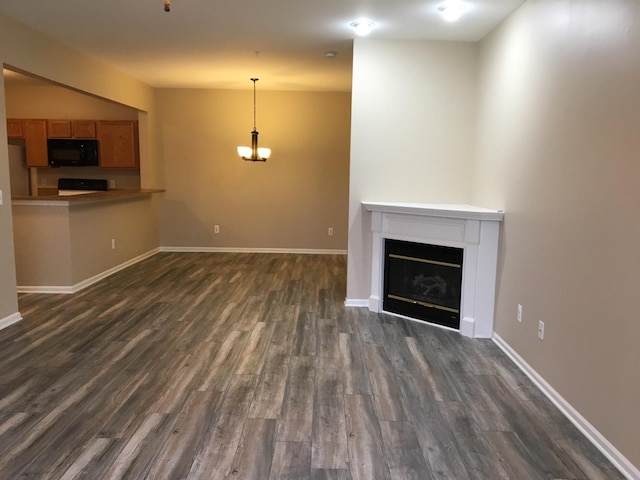 unfurnished living room featuring dark hardwood / wood-style flooring