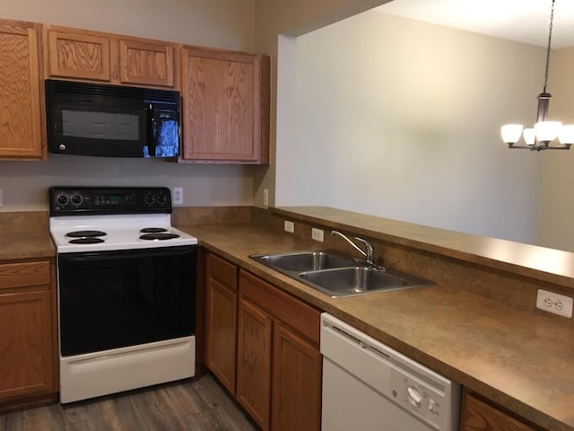 kitchen featuring an inviting chandelier, white dishwasher, hanging light fixtures, electric range oven, and sink