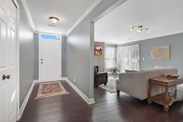 foyer with ornamental molding and dark hardwood / wood-style flooring