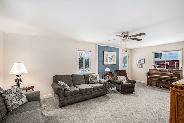 living room featuring a brick fireplace, ceiling fan, and carpet flooring