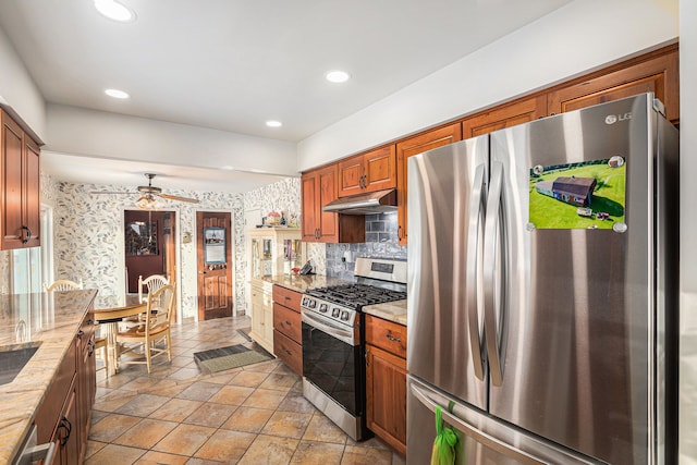 kitchen with sink, stainless steel appliances, and tasteful backsplash