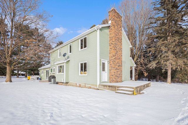 view of snow covered rear of property