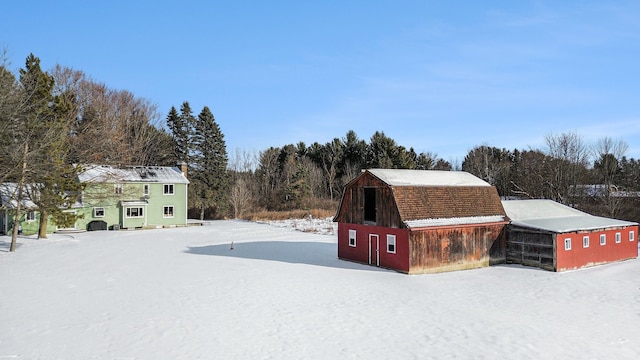 yard layered in snow with an outdoor structure