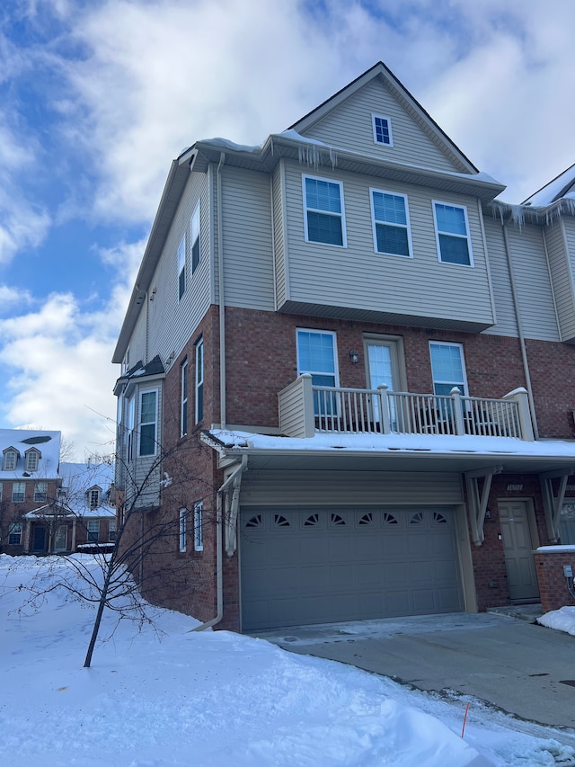 view of front of property featuring a garage and a balcony