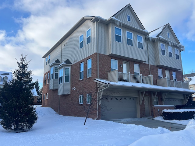 view of property with a garage and a balcony